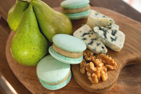 Macaroons, Crushed Walnuts And Dried Apricots On A Wooden Surface