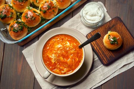 National ukrainian red borscht with sour-cream and buns pampushki.の写真素材