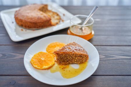 Homemade orange cake on a dark wooden kitchen table. Vegan and Gluten Freeの写真素材