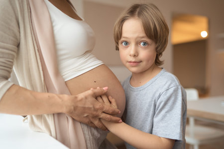little boy listening to mom pregnant belly