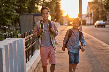 School boys running to school. School boys having fun after school.の写真素材
