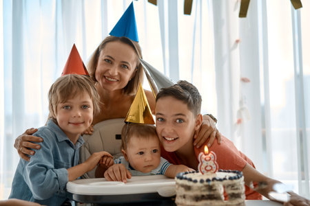 Happy young family with friends celebrates birthday of a child of 8 months. The first year of life....