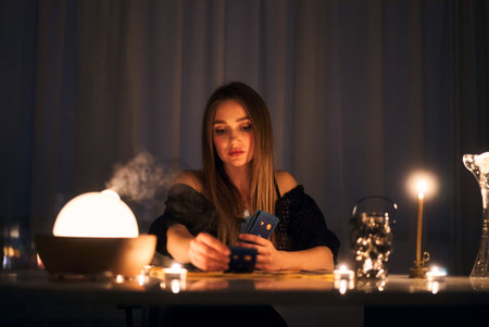 Woman reading tarot cards in spiritual room.