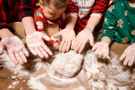 Mom and children bake cookies in the kitchen and decorate cookies on Christmas Eve, the top view. Making christmas cookies.の写真素材