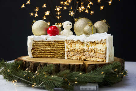 A slice of a cake on a background of christmas lights.の写真素材