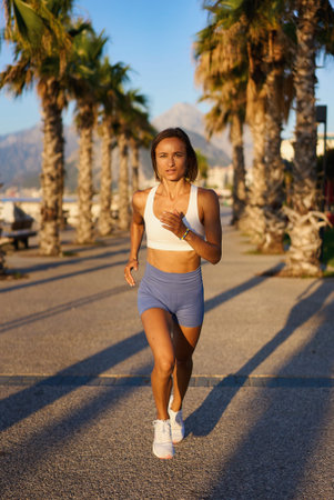 young healthy lifestyle woman running at sunrise beach