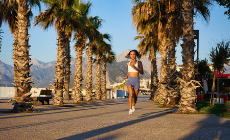 young healthy lifestyle woman running at sunrise beach