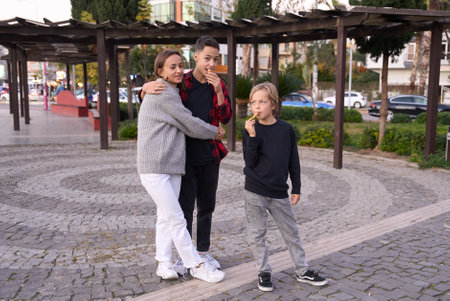 Family in a summer park. Mother and her sons with ice cream in the city.の写真素材