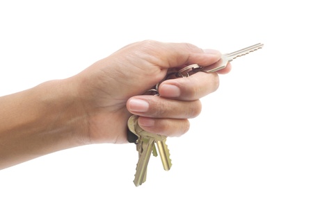 metal keys in woman hand isolated on the white background.の写真素材