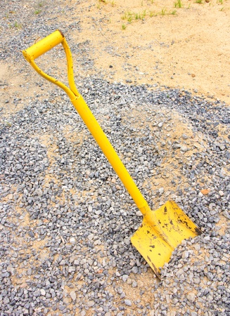 Yellow shovel in a graniteの写真素材