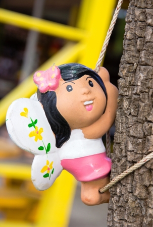 Doll- girl climbing trees with rope.の写真素材