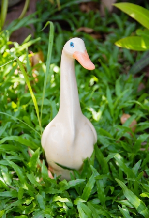 Duck is made of ceramic among the green grassの写真素材