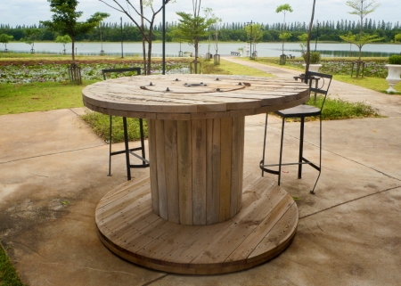 Wooden table and chairs in garden の写真素材