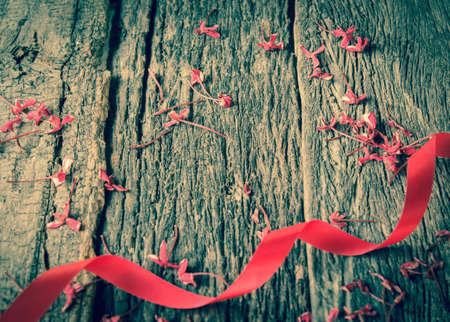 Red ribbon on old wood.の写真素材