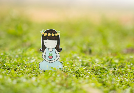 Young woman meditating in nature.の写真素材