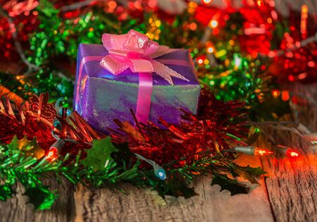 Christmas gift boxes with light on wood.の写真素材