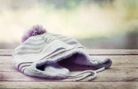knitted wool hat isolated on woodの写真素材