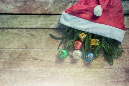 Christmas background with a blue ornament, golden gift box on wood.の写真素材