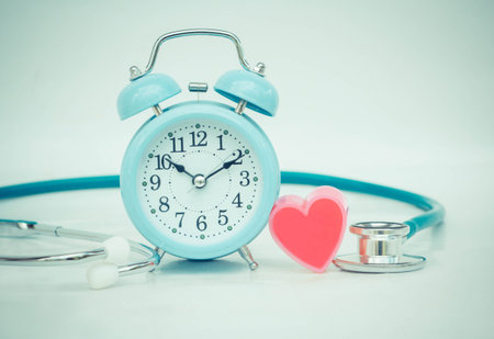 Stethoscope with heart and alarm clock.