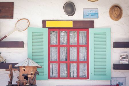 Open vintage window with flower on brick wallの写真素材