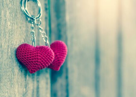 Valentines Day background with hearts hanging on wood.の写真素材