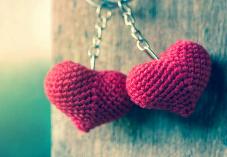 Valentines Day background with hearts hanging on wood.の写真素材