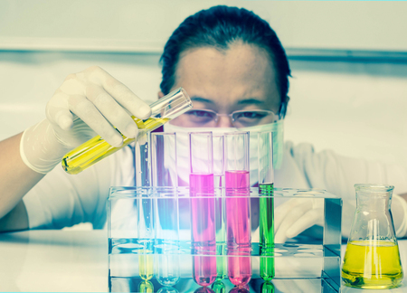 Medical or scientific researcher with flask making test or research in clinical laboratoryの写真素材