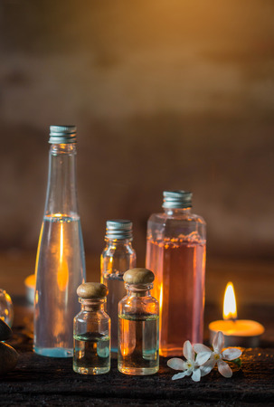 Spa treatment with scented candles and soap on wood.の写真素材
