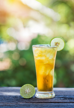 glass of iced tea with lemon on wooden.の写真素材