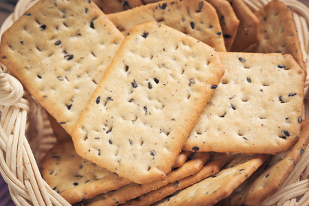 Stack of square crackers in basket.の写真素材