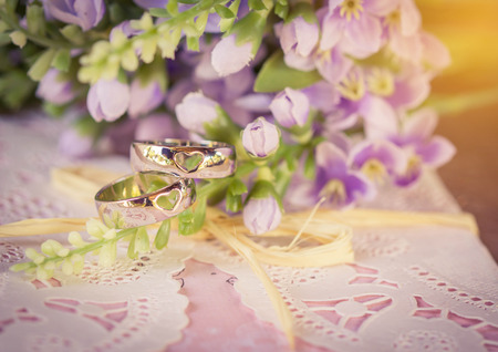Wedding rings with card and flower.の写真素材
