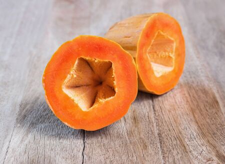 Sliced fresh papaya on wooden backgroundの写真素材