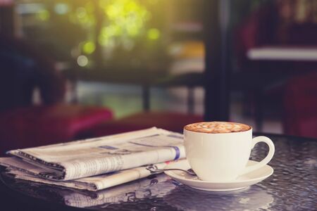 cup of coffee with Newspaper in coffee shop.の写真素材