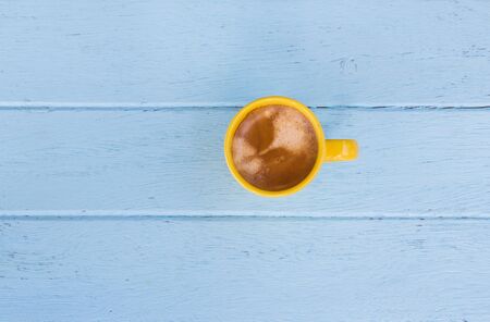 Coffee cup top view on blue wooden table backgroundの写真素材