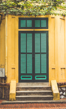 Green wooden door with tree.のeditorial素材