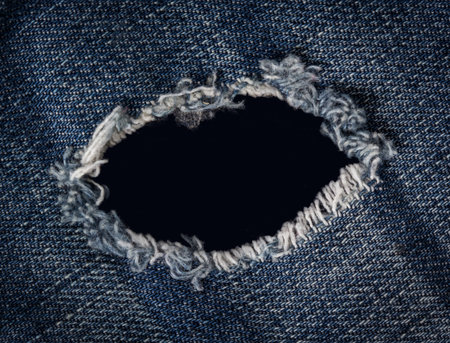 Blue torn denim jeans texture background.