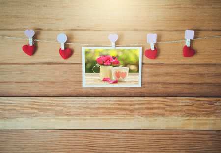 Red heart with Blank white card hanging on wooden for valentine day love concept.の写真素材