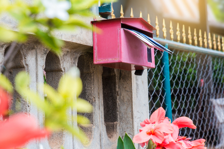 Red Mail Box in Front of a houseの写真素材