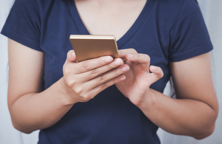 Closeup image on a female hands holding smartphoneの写真素材