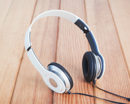 headphones on wooden table,Audio technology and music concept.の写真素材