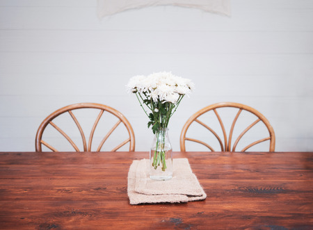 Wood table top and white flower in restaurant.の写真素材