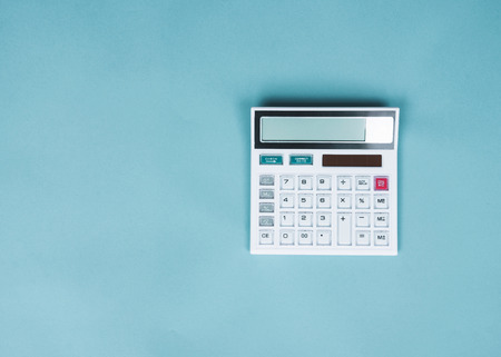 Calculator on blue background, Top viewの写真素材