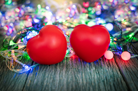 Valentines Day background with hearts and light on wood background.の写真素材