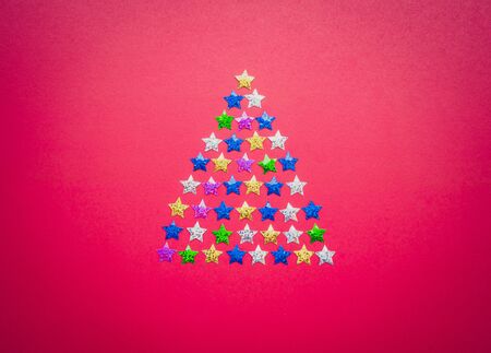 christmas tree made from stars on red background.の写真素材