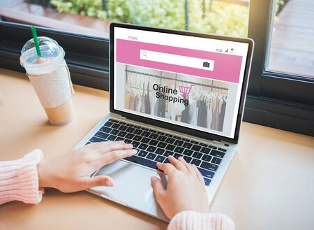 Online Shopping Website on laptop.Young woman hands using laptop computer.の写真素材