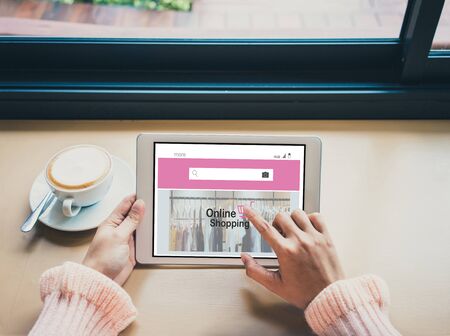 Online Shopping Website on digital tablet.Young woman hands using digital tablet. Online shopping concept.の写真素材