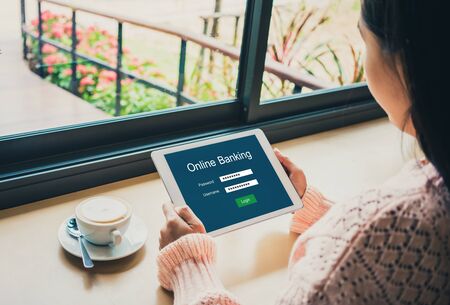 Young woman holding credit card and using online banking on digital tablet.Financial and investment and internet payments shopping network.
の写真素材
