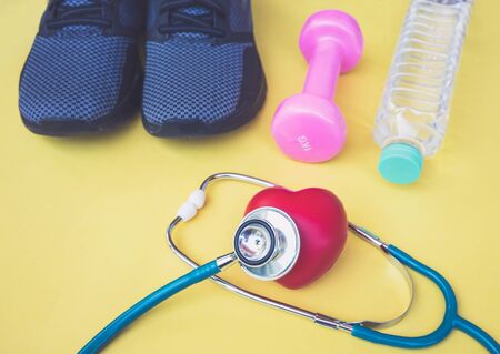 Healthcare concept ,stethoscope with sport shoes and bottle of water and Dumbell.の写真素材