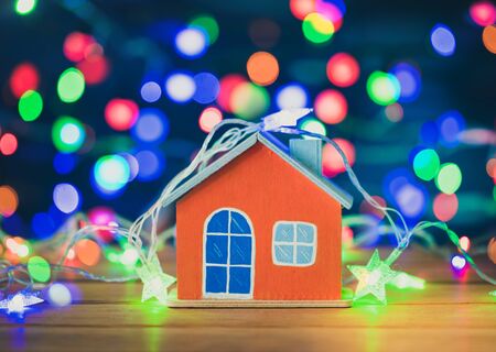Orange house on wood with christmas light decorations.の写真素材