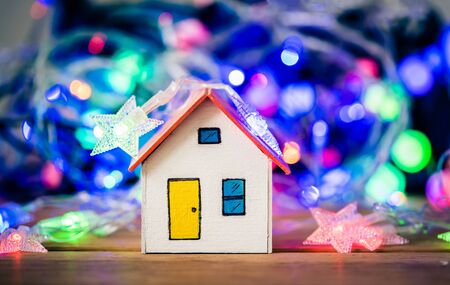 Orange house on wood with christmas light decorations.の写真素材